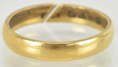 Lot 1465 - A 22ct gold band ring with a cut shank, approx...
