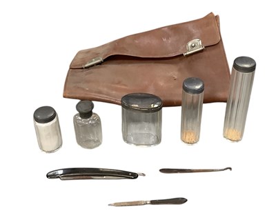Lot 1317 - A leather travelling vanity case, with five...
