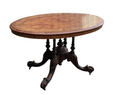 Lot 23 - A Victorian walnut oval loo table, on carved...
