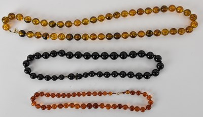 Lot 1563 - An amber style beaded necklace, length 72cm, a...