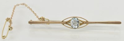 Lot 1501 - A 9ct gold bar brooch with central bezel set...