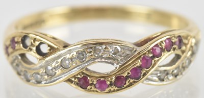 Lot 1500 - A 9ct gold ruby and diamond crossover ring,...