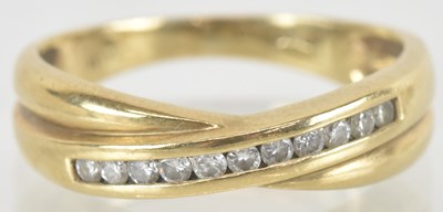 Lot 1510 - A 9ct gold eternity ring with a central...