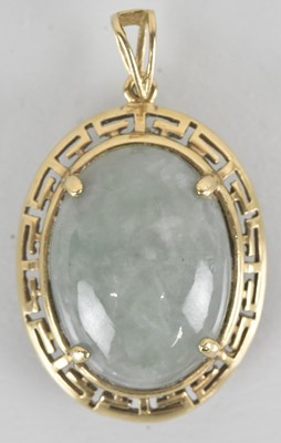 Lot 1507 - A half jade cabochon claw set in a 9ct gold...