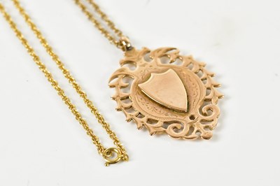 Lot 368 - A 9ct yellow gold pierced shield shaped fob,...