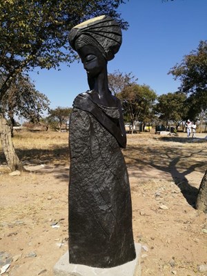 Lot 1017 - An African carved springstone figure of lady...