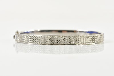 Lot 1536 - An 18ct white gold and pavé set diamond oval...