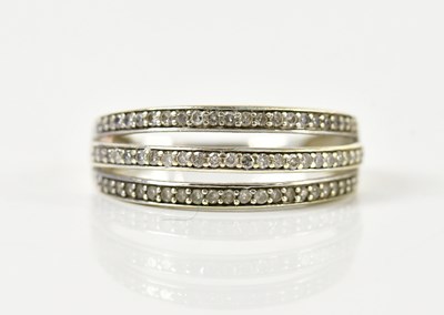 Lot 163 - A 9ct white gold pierced three row dress ring,...