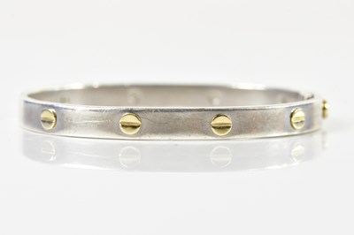 Lot 1559 - A silver oval hinged bangle after the original...
