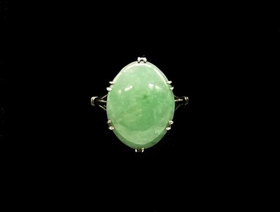 Lot 1183 - An 18ct white gold and jade oval cabochon ring,...