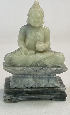 Lot 250 - A Chinese carved soapstone Buddha, modelled on...