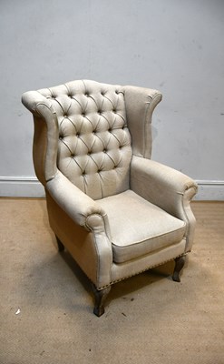 Lot 2456 - A contemporary wing armchair on limed oak...