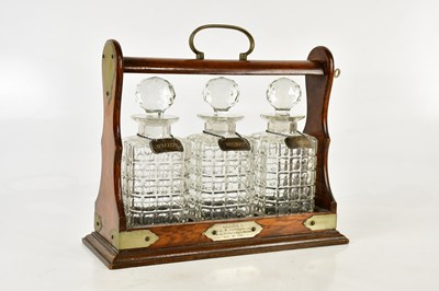 Lot 1333 - An Edwardian oak tantalus with silver plated...