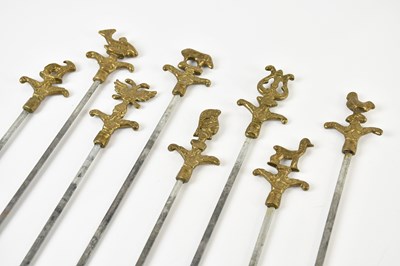 Lot 2639 - A set of eight brass skewers, 42cm.