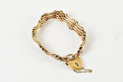 Lot 1551 - A 9ct yellow gold textured gate link bracelet...