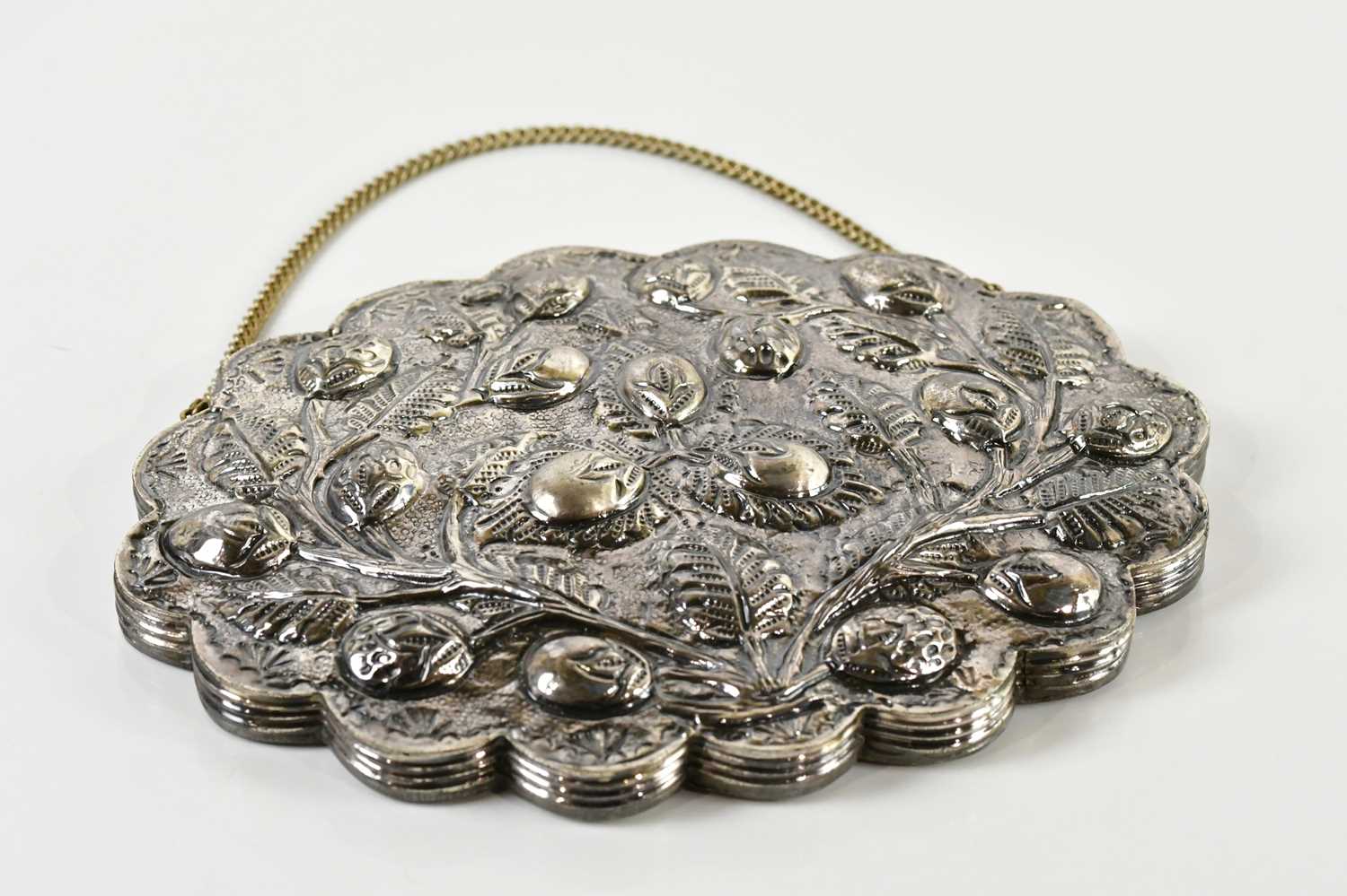 Lot 86 - A shaped oval mirror with bud and leaf...