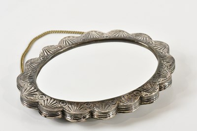 Lot 86 - A shaped oval mirror with bud and leaf...