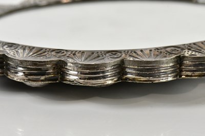 Lot 86 - A shaped oval mirror with bud and leaf...