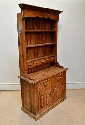 Lot 2254 - A pine dresser the boarded plate rack back...