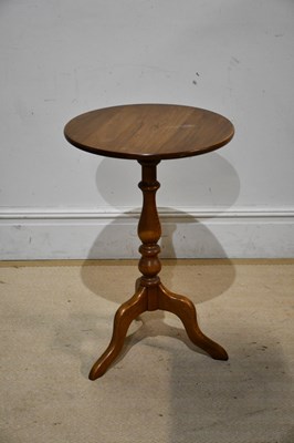 Lot 2212 - ERCOL; a medium elm tripod table, height 75cm.