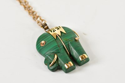 Lot 1628 - A 9ct yellow gold chain suspending a carved...