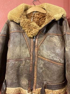 Lot 86 - A vintage sheepskin flying jacket. Proceeds to...
