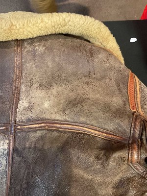 Lot 86 - A vintage sheepskin flying jacket. Proceeds to...