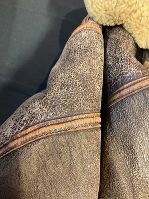 Lot 86 - A vintage sheepskin flying jacket. Proceeds to...