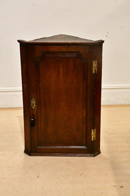 Lot 2297 - A Georgian oak corner cupboard with three...