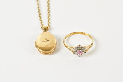 Lot 402 - A yellow metal locket suspended with a central...