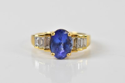 Lot 1399 - An 18ct yellow gold tanzanite and diamond ring,...