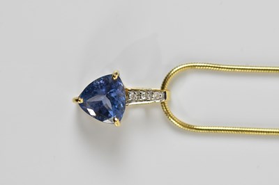 Lot 1640 - A yellow metal tanzanite and diamond pendant,...