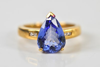 Lot 1424 - An 18ct yellow gold tanzanite and diamond ring,...