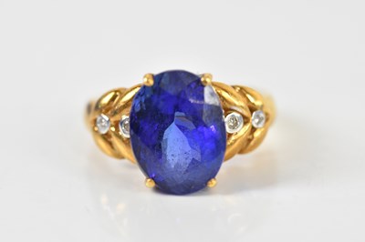 Lot 1326 - An 18ct yellow gold tanzanite and diamond ring,...