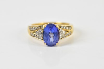 Lot 1395 - An 18ct yellow gold tanzanite and diamond ring,...