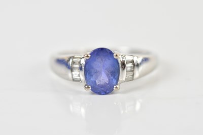 Lot 1489 - An 18ct yellow gold tanzanite and diamond ring,...