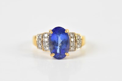Lot 1416 - An 18ct yellow gold tanzanite and diamond ring,...
