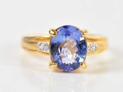Lot 1417 - An 18ct yellow gold tanzanite and diamond ring,...