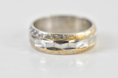 Lot 1414 - An 18ct white gold wedding band, size K,...
