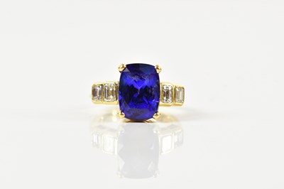 Lot 1284 - An 18ct yellow gold tanzanite and diamond ring,...