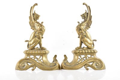 Lot 2636 - A pair of brass firesides modelled as griffins,...