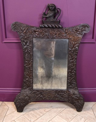 Lot 2219 - A late 19th century carved oak mirror, the...