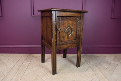 Lot 2274 - A carved oak pot cupboard, with panelled door,...