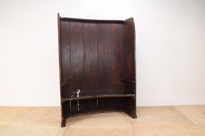 Lot 2236 - A George III stained pine curved settle,...