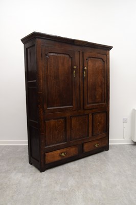 Lot 2301 - A George III oak livery cupboard, with two...