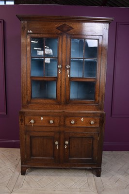 Lot 2240 - An early 19th century oak cupboard (Cwpwrdd...