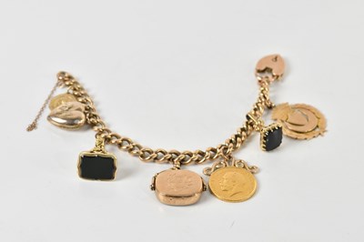 Lot 1531 - A 9ct gold curb link charm bracelet, with 9ct...