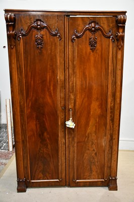 Lot 2392 - A Victorian carved mahogany wardrobe, with two...