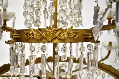 Lot 98 - A three-tiered gilt brass and cut glass...