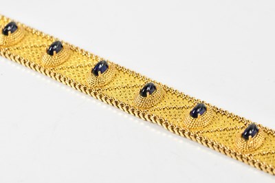 Lot 1530 - A broad yellow metal textured bracelet set...